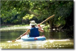 Image of person canoing on river